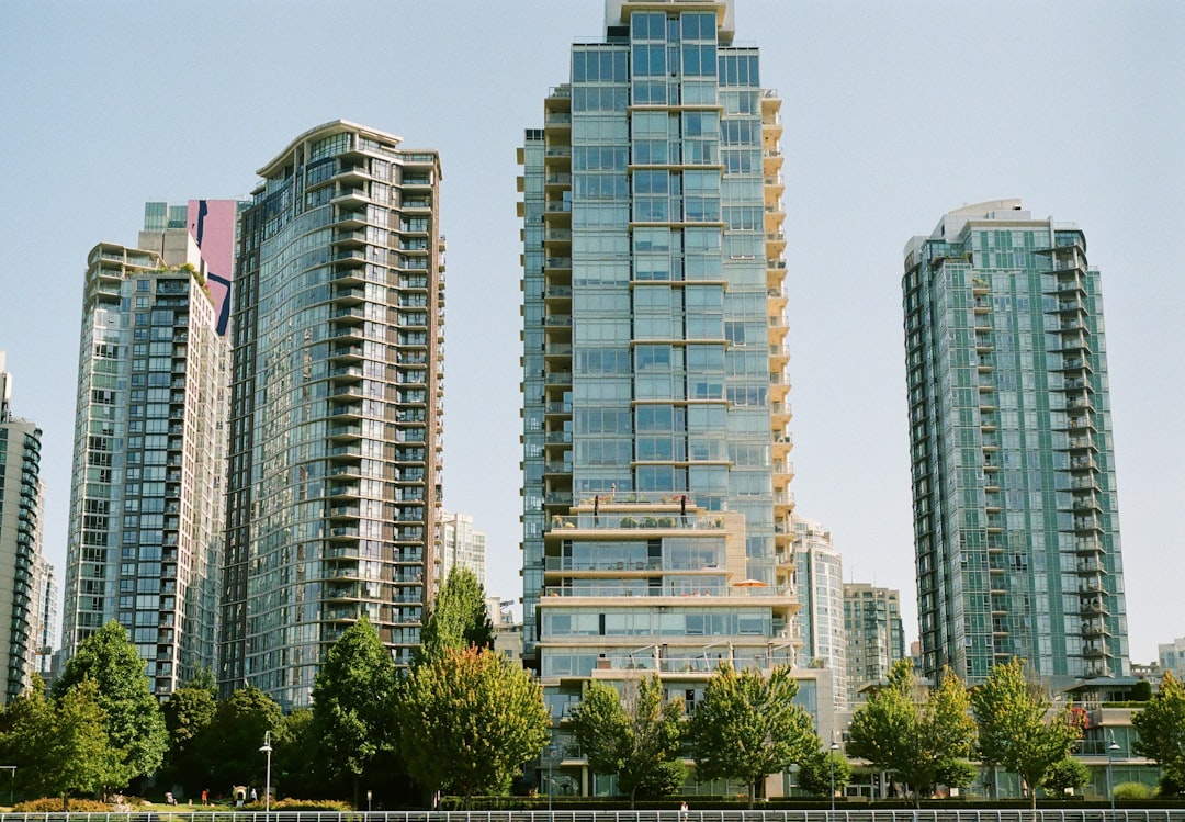 Green trees near Vancouver residential high-rise buildings