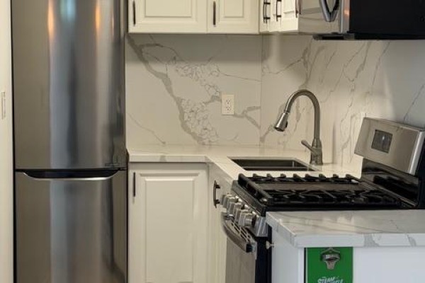 Close up of stainless steel refrigerator, gas stove and white countertop. - (basement) - 366 Waratah Avenue, Newmarket