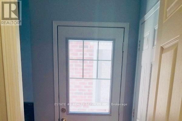 Empty room with a window, laminate flooring, and neutral walls - (bsmt) - 12 Locarno Street, Brampton