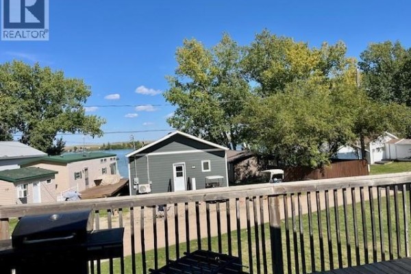 View from deck shows houses, trees, and water in the distance. - Cabin 94 At Clearwater Regional Park, Lacadena Rm No  228
