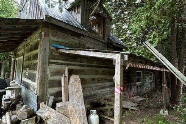 Loft area with wood flooring, large water tank, and a window. - 0 Armstrong Road, Merrickville Wolford