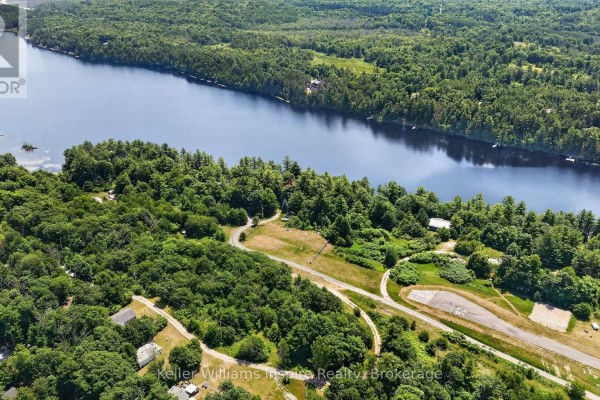 Aerial perspective of the landscape featuring a large body of water and dense green forest. - 0 Baker Valley Road, Frontenac