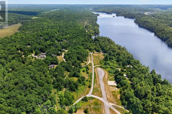 Expansive aerial shot of a lakefront property with a runway and abundant trees. - 0 Baker Valley Road, Frontenac