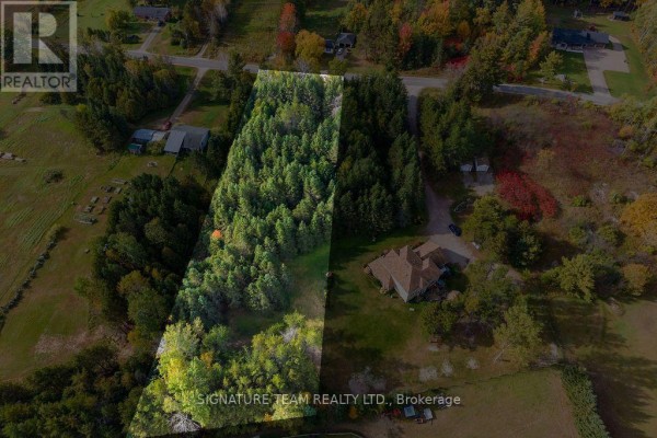 Aerial view showing a large property with a wooded area, a house, and surrounding rural landscape. - 0 Dombroskie Road, Whitewater Region