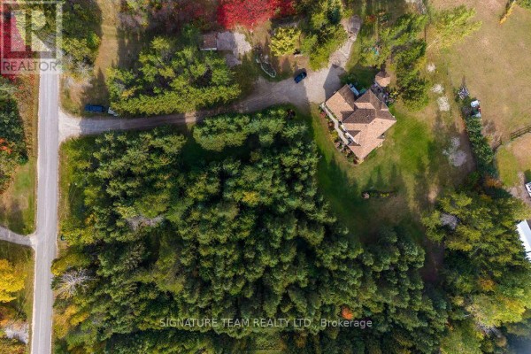 Top-down view of a property with a winding driveway leading to a house surrounded by trees. - 0 Dombroskie Road, Whitewater Region