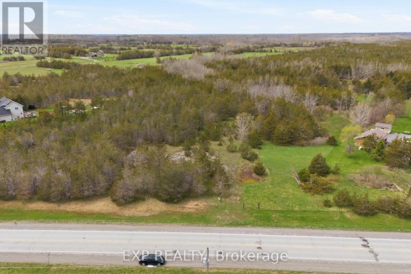 Aerial view of wooded land with scattered houses and fields, beside a highway. - 0 Highway 49 Highway W, Prince Edward County