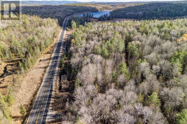Aerial view of Highway 17 beside a forest with a lake visible in the distance. - 0 Hwy 17 Highway, Laurentian Hills