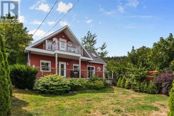 Aerial view of a red house on a corner lot with surrounding trees and other houses. - 0 Main Road, Bauline East