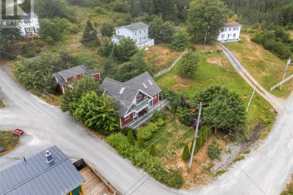 A red house with white trim and multiple windows, with a second-floor balcony. - 0 Main Road, Bauline East