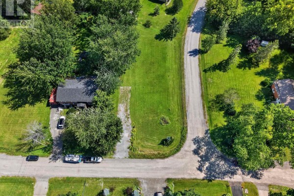 Aerial view of the property at 0 Noxon Road, including the house, driveway, and surrounding greenery. - 0 Noxon Road, Greater Napanee