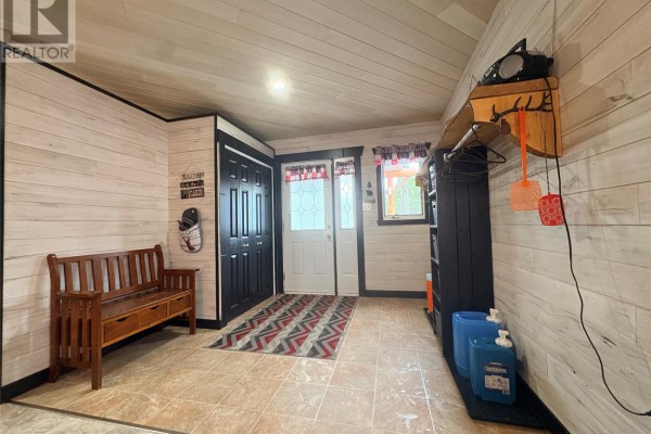 Entryway with a wooden bench, black bi-fold doors, and a glass-paned front door. - 0 Wilf Keats Road, Between Stanhope Brown S Arm