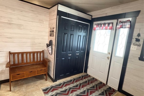 Open-concept dining and kitchen area with a wooden table, red refrigerator, and wooden cabinets. - 0 Wilf Keats Road, Between Stanhope Brown S Arm