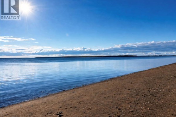 View of a calm blue ocean from a sandy beach on a sunny day. - 0.2 Acres Rue Stella, Pointe Brulee