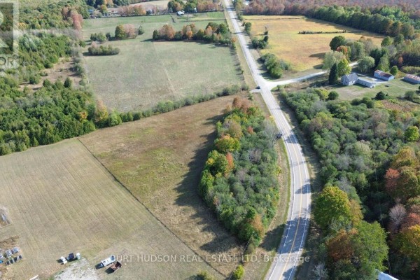 Aerial view of land with a mix of fields and trees, near a road and residential buildings. - 00 County Road 7 Road, Elizabethtown Kitley