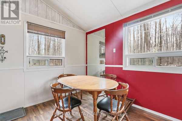 Interior view of cabin with dining table, chairs, and windows looking out to trees. - 00 Part Of Lot 11 Gagne Road, Clarence Rockland
