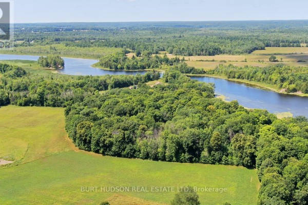 Aerial image featuring a river winding through green forests and open fields. - 003 Lyndhurst Road, Leeds And The Thousand Islands