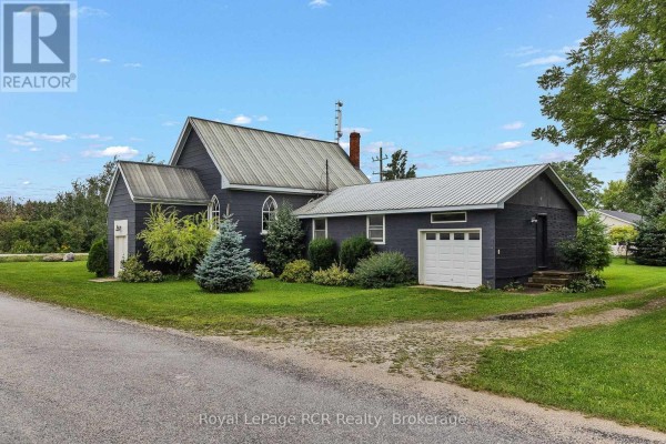 Dark home with metal roof & pointed arch windows, attached garage - 046285 Old Mail Road Meaford