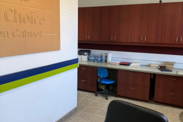 Office space with dark wood cabinets, beige countertops, a blue chair, and filing cabinets. - 1 - 11 Goodmark Place, Toronto