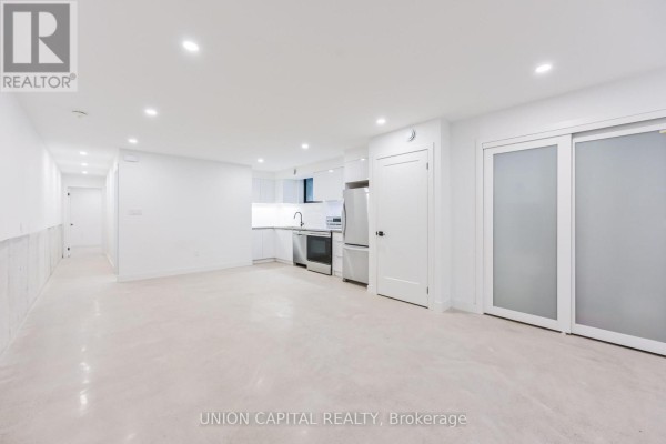 Wide view of white open concept living space with a kitchenette. - 1 - 156 Dovercourt Road, Toronto