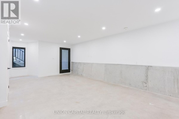 Large unfinished basement room with concrete walls and floors. - 1 - 156 Dovercourt Road, Toronto