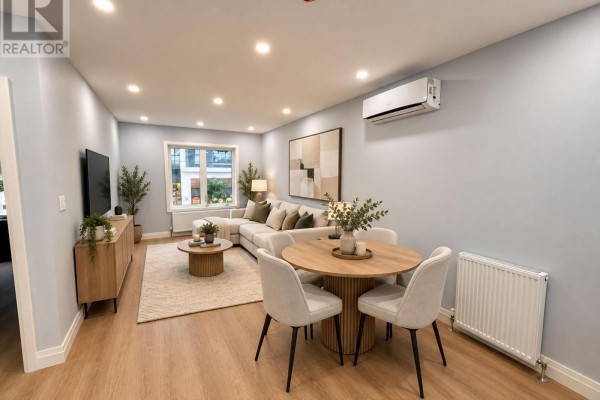 Living and dining area with sectional sofa, round table, and light blue walls. - 1 - 1727a Bayview Avenue, Toronto