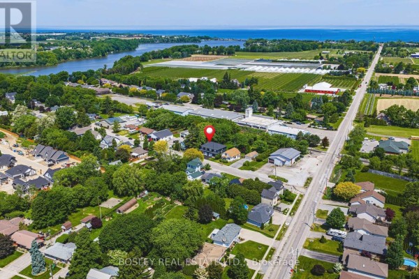 Aerial view of a large, dark green house surrounded by mature trees and a grassy backyard. - 1 - 2727 Prince William Street, Lincoln