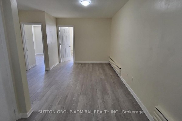 Spacious living area with laminate flooring and multiple entry points. - 1 - 2839 Bathurst Street, Toronto