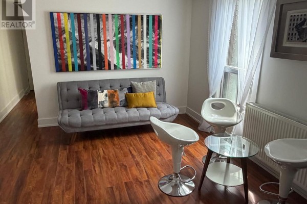 Hallway with a skylight, white walls, and wood-look laminate flooring. - 1 - 2886 Lake Shore Boulevard W, Toronto