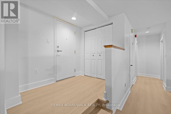Modern kitchen with white cabinets, stainless steel appliances, a wood island, and dining area. - 1 - 45 Mill Street, Carleton Place