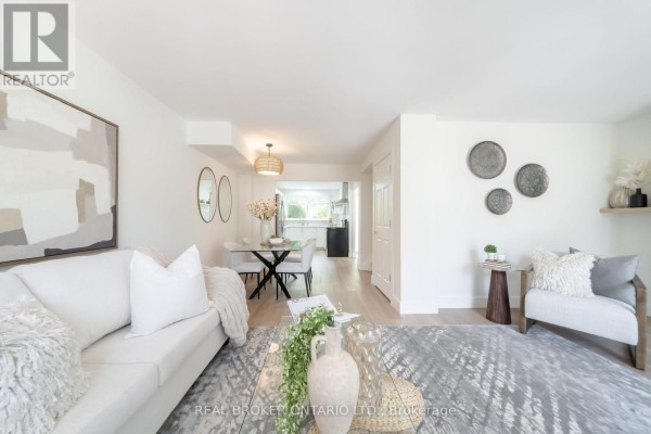 Living and dining area with neutral colors and a view into the kitchen. - 1 - 684 Dynes Road, Burlington