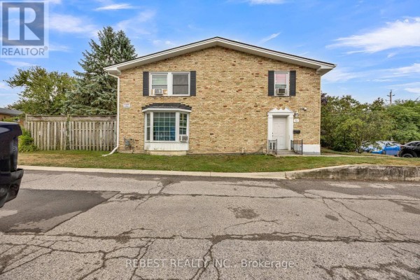 Front exterior of a two-story brick townhouse with a bay window on the first floor. - 1 - 73 Arbour Glen Crescent, London East