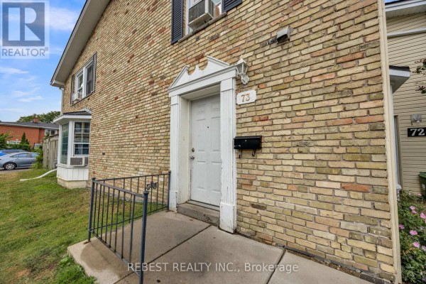 Close-up of a white front door with a decorative archway and number 73 on brick exterior. - 1 - 73 Arbour Glen Crescent, London East
