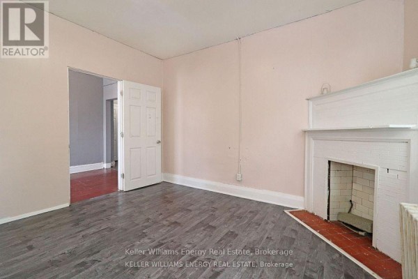 Interior doorway view showing two doors and a kitchenette entrance. - 1 - 84 Simcoe Street N, Oshawa