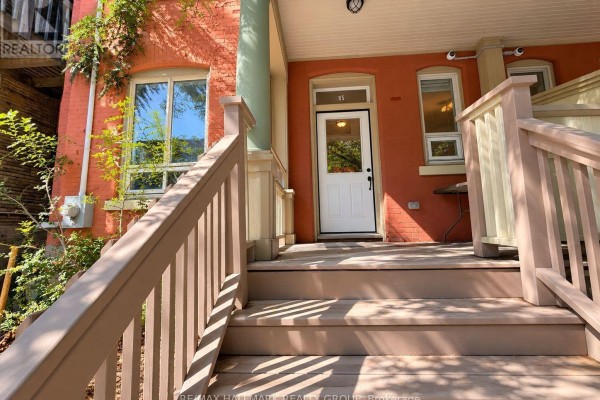 Close-up of the front door and porch area of the red brick townhouse. - 1 - 85 Park Avenue, Ottawa