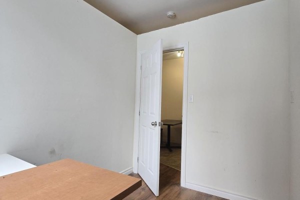 Spacious area with wood flooring and a small step-up platform - 1 - 88 Colborne Street, Brantford