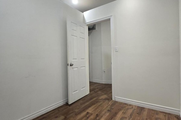 Empty hallway with a door leading to a small room or closet - 1 - 88 Colborne Street, Brantford