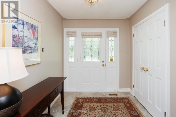 Entrance hallway with a glass-paneled front door, console table, and rug. - 1 - 90 Parklawn Boulevard, Brock