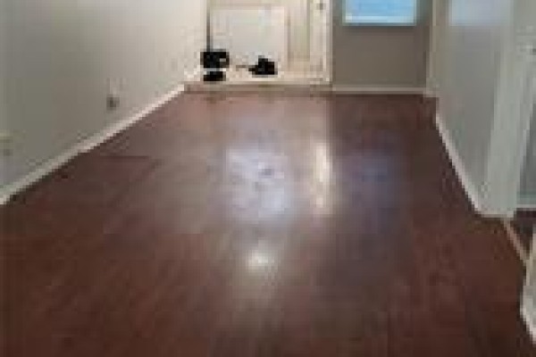 Living room with dark hardwood floors, white walls, and fireplace. - 1-205 Kenilworth Avenue N Unit# 1, Hamilton