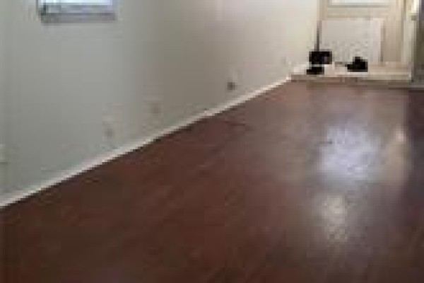 View across the living room with hardwood floors and light gray walls. - 1-205 Kenilworth Avenue N Unit# 1, Hamilton