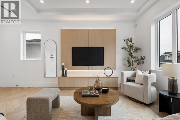 A bathroom with a glass-enclosed shower, white toilet, and a wood vanity. - 1 3637 E 46th Avenue, Vancouver