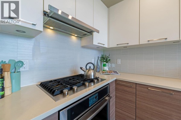 Bedroom with a queen-size bed, bedside tables, and a sliding door closet. - 1 8599 River District Crossing, Vancouver
