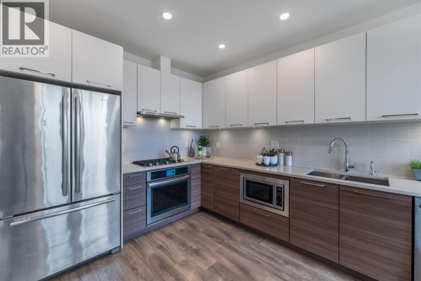 Well-equipped fitness center with treadmills, weight machines, and free weights. - 1 8599 River District Crossing, Vancouver