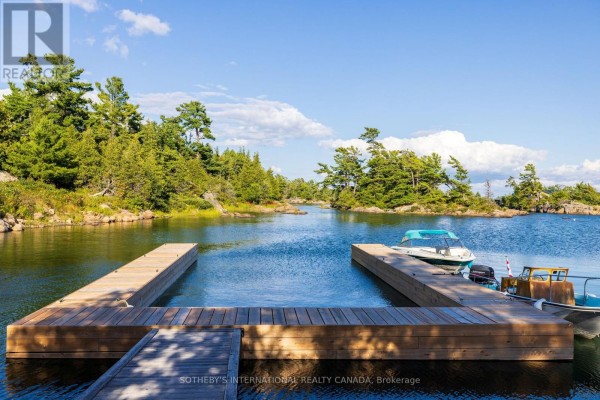 Wooden dock with boats on a lake - 1 A307 Island The Archipelago