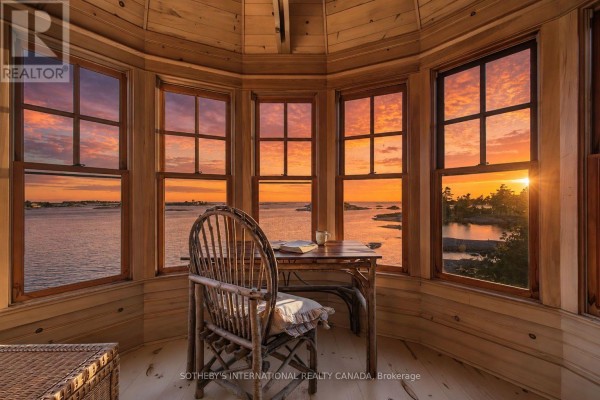 Wooden desk and chair in a circular room with multi-paned windows. - 1 A307 Island, The Archipelago