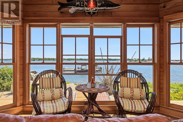 Waterfront living room with wicker chairs & large windows - 1 A307 Island The Archipelago