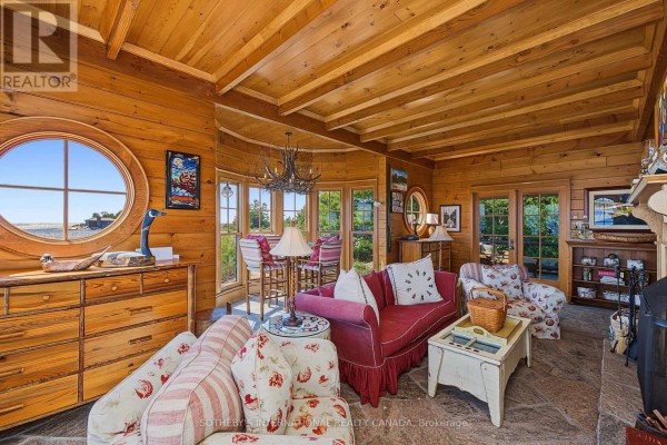 Living room with round window, wood paneled walls, and water view - 1 A307 Island The Archipelago