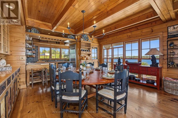 Dining room with lake view, round table, wood paneling & beamed ceiling - 1 A307 Island The Archipelago