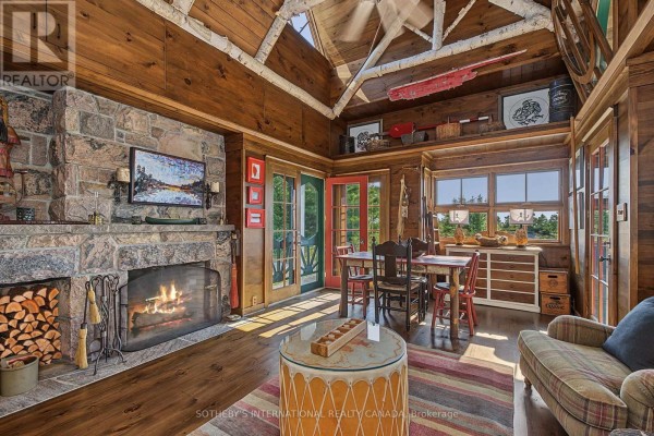 Living room with stone fireplace, wood ceilings, dining table, and sofa - 1 A307 Island The Archipelago