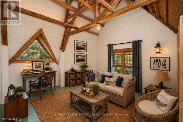 Living room with wood beams, wicker sofa & chair, triangle window, and lake decor - 1 A307 Island The Archipelago