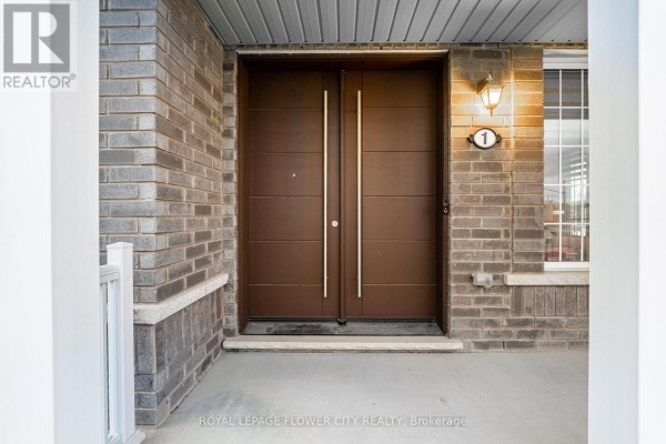 Close-up of the main entrance with double doors and brick detailing. - 1 Anderson Road, Brantford